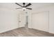 Bedroom featuring modern gray flooring, closet, and ceiling fan at 308 W Oraibi Dr, Phoenix, AZ 85027
