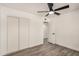Spacious bedroom with hardwood floors, ceiling fan and sliding-door closet for optimal organization at 308 W Oraibi Dr, Phoenix, AZ 85027
