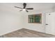 Bright bedroom with light gray wood flooring and a window for natural light at 308 W Oraibi Dr, Phoenix, AZ 85027