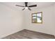 Cozy bedroom featuring wood-look floors, ceiling fan, and natural light at 308 W Oraibi Dr, Phoenix, AZ 85027