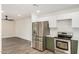 Kitchen featuring stainless steel appliances, white countertops, and green cabinets at 308 W Oraibi Dr, Phoenix, AZ 85027