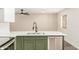 Kitchen with sleek stainless steel appliances and modern green lower cabinets at 308 W Oraibi Dr, Phoenix, AZ 85027