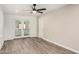 Bright living room featuring gray wood flooring and access to enclosed patio at 308 W Oraibi Dr, Phoenix, AZ 85027