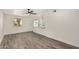 Open living area showcasing windows, gray wood flooring, and views into kitchen at 308 W Oraibi Dr, Phoenix, AZ 85027