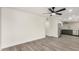 Open-concept living room featuring modern gray wood flooring and a ceiling fan at 308 W Oraibi Dr, Phoenix, AZ 85027