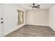 Bright living room featuring new flooring, fresh paint, and a modern ceiling fan at 308 W Oraibi Dr, Phoenix, AZ 85027