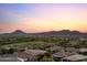 Panoramic aerial of desert homes with mountain views at sunset at 31210 N 122Nd Ln, Peoria, AZ 85383