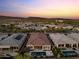 Beautiful aerial view of homes with private pools and mountain views at sunset at 31210 N 122Nd Ln, Peoria, AZ 85383