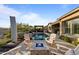 Relaxing backyard features a sparkling pool, pergola, fire pit, and comfortable lounge chairs at 31210 N 122Nd Ln, Peoria, AZ 85383