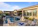 Inviting backyard with a pool, fire pit, and Adirondack chairs for relaxing outdoors at 31210 N 122Nd Ln, Peoria, AZ 85383