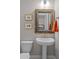 Cozy bathroom featuring a pedestal sink, decorative mirror, and orange hand towels at 31210 N 122Nd Ln, Peoria, AZ 85383