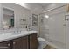 Modern bathroom featuring a sleek glass-enclosed shower, neutral tile, and a stylish vanity area at 31210 N 122Nd Ln, Peoria, AZ 85383