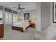 Cozy bedroom with soft lighting, neutral decor, and a comfortable bed, creating a relaxing retreat at 31210 N 122Nd Ln, Peoria, AZ 85383