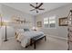 Serene bedroom featuring a comfortable bed, neutral tones, and ample natural light from the window at 31210 N 122Nd Ln, Peoria, AZ 85383