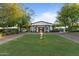 Beautiful clubhouse with manicured lawn, elegant landscaping, and charming architectural details, perfect for community gatherings at 31210 N 122Nd Ln, Peoria, AZ 85383