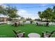 Common area featuring Adirondack chairs, cornhole, bocce ball court, artificial turf and string lights, great for entertaining at 31210 N 122Nd Ln, Peoria, AZ 85383