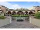 Beautiful courtyard featuring brick pavers, fountain, arches, and lush landscaping at 31210 N 122Nd Ln, Peoria, AZ 85383