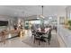 Open-concept dining area with a large table, comfortable seating, and seamless integration with the outdoor living space at 31210 N 122Nd Ln, Peoria, AZ 85383