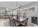 Bright dining area featuring a large table with seating, modern lighting, and access to adjacent living spaces at 31210 N 122Nd Ln, Peoria, AZ 85383