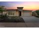 Beautiful home featuring a stone facade, desert landscaping, and a brick driveway at 31210 N 122Nd Ln, Peoria, AZ 85383