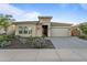 Attractive house featuring a stone facade, desert landscaping, and well-kept curb appeal at 31210 N 122Nd Ln, Peoria, AZ 85383