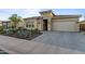 Inviting house featuring a stone facade, desert landscaping, and a brick driveway at 31210 N 122Nd Ln, Peoria, AZ 85383