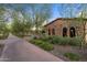 Charming stone building surrounded by lush landscaping and mature trees at 31210 N 122Nd Ln, Peoria, AZ 85383