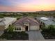 Impressive aerial shot of a home with a well-manicured front yard at sunset at 31210 N 122Nd Ln, Peoria, AZ 85383