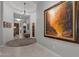 Elegant hallway with tile flooring, neutral walls, and an impressive art collection at 31210 N 122Nd Ln, Peoria, AZ 85383