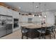Bright kitchen featuring stainless steel appliances, stone countertops, a large island, and seating for guests at 31210 N 122Nd Ln, Peoria, AZ 85383