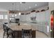 Modern kitchen with a large island, stainless steel appliances, stone countertops, and decorative backsplash at 31210 N 122Nd Ln, Peoria, AZ 85383