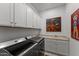 Well-equipped laundry room features a modern washer and dryer, and ample storage cabinets at 31210 N 122Nd Ln, Peoria, AZ 85383