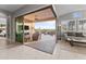 Bright living room with large sliding doors providing access to the outdoor space, pool, and landscaped surroundings at 31210 N 122Nd Ln, Peoria, AZ 85383