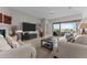 Inviting living room featuring comfortable seating and a large sliding glass door leading to a relaxing outdoor patio at 31210 N 122Nd Ln, Peoria, AZ 85383