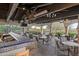 Inviting outdoor bar and seating area, complete with brick flooring, overhead beams, and scenic views at 31210 N 122Nd Ln, Peoria, AZ 85383