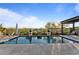 Relaxing backyard pool with lounge chairs, desert landscaping, and a clear blue sky at 31210 N 122Nd Ln, Peoria, AZ 85383