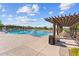 Community pool with ample lounge chairs and shade, perfect for relaxing and enjoying the Arizona sunshine at 31210 N 122Nd Ln, Peoria, AZ 85383