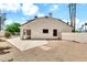 This backyard shows a patio, block wall, rock landscaping and an open area with a pool visible in the distance at 3389 W Barcelona Dr, Chandler, AZ 85226