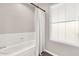 Bright bathroom featuring a tub with a new shower curtain and a window at 3389 W Barcelona Dr, Chandler, AZ 85226
