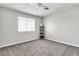 Cozy bedroom features neutral walls, soft carpeting, ceiling fan and a large window at 3389 W Barcelona Dr, Chandler, AZ 85226
