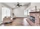 Bright living room with vaulted ceilings, a brick fireplace, and large windows at 3389 W Barcelona Dr, Chandler, AZ 85226
