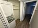 Convenient laundry area features a stacked washer and dryer with storage shelves at 3434 W Danbury Dr # A206, Phoenix, AZ 85053