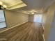 Spacious living room featuring wood floors, tray ceiling, large windows, and natural light at 3434 W Danbury Dr # A206, Phoenix, AZ 85053