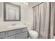 Bathroom featuring modern gray vanity and a shower with curtain at 3685 N 141St Dr, Goodyear, AZ 85395