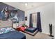 A decorated bedroom featuring a Batman-themed wall and two beds at 3685 N 141St Dr, Goodyear, AZ 85395