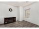 Cozy bonus room featuring wood-look flooring, a clock, and an electric fireplace at 3685 N 141St Dr, Goodyear, AZ 85395