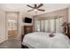Relaxing main bedroom with sitting area, ceiling fan, tv and plenty of natural light at 3685 N 141St Dr, Goodyear, AZ 85395