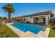 Private backyard pool with a lush green turf area and a patio at 3685 N 141St Dr, Goodyear, AZ 85395