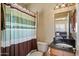 Bathroom featuring a shower with patterned curtain, granite countertop, and wooden cabinets at 4136 E Greenway Cir, Mesa, AZ 85205
