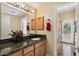 Well-appointed bathroom with granite countertop, wooden cabinets, and neutral walls at 4136 E Greenway Cir, Mesa, AZ 85205